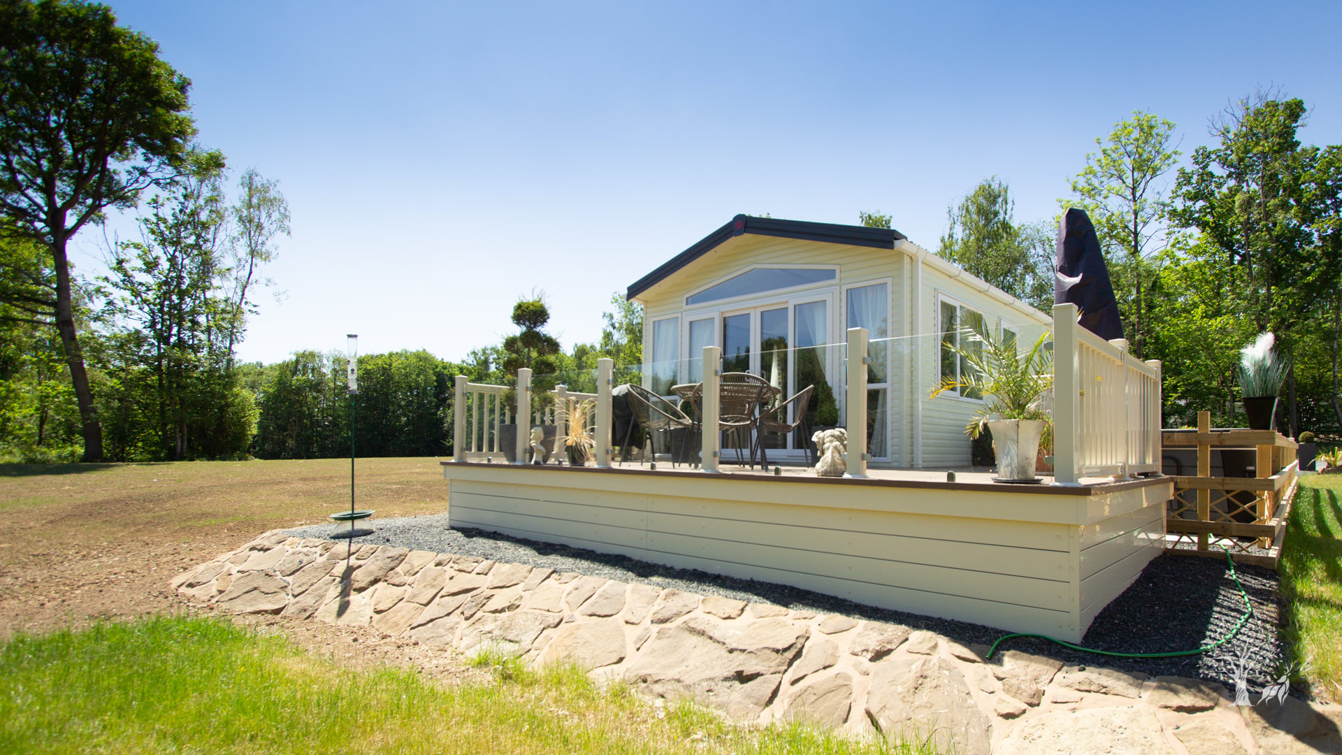 Local quarried stone around the decking on a static caravan.