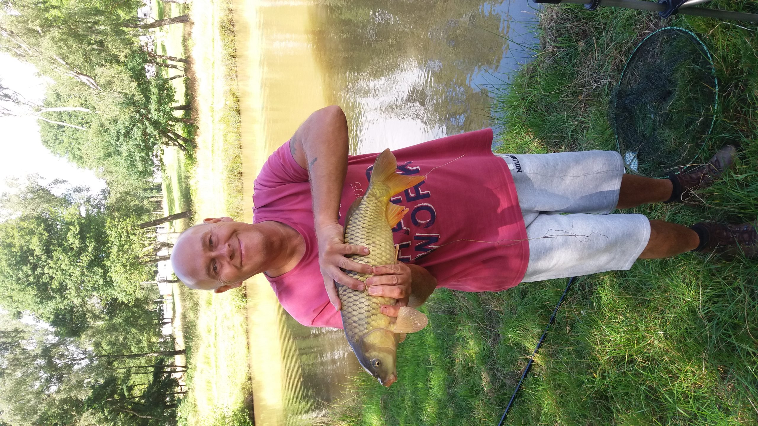 20160807_111329 (1) A fisherman shows of the large fish he has caught.