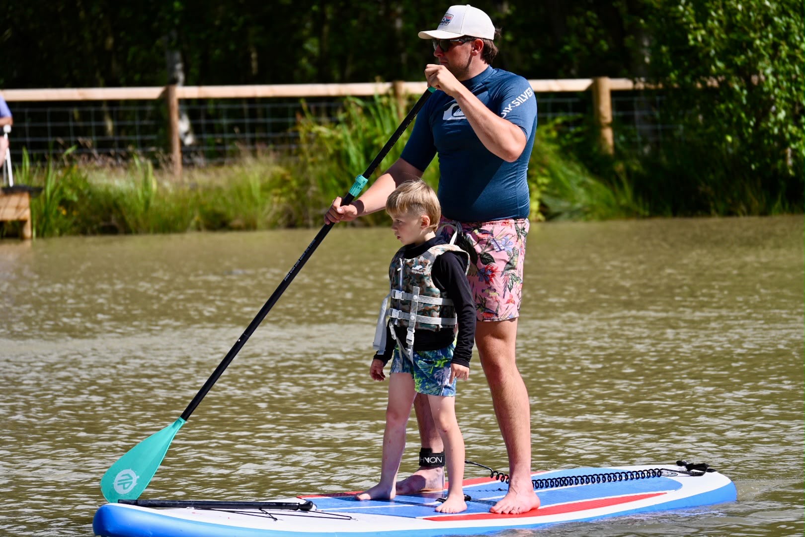 250a2189-62fa-43c4-be90-5918cc6905d6 Adult and child paddleboard on the non-motorised water sports lake